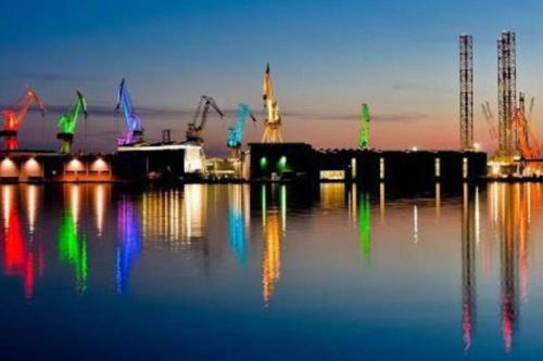 a group of cranes in a harbor at night at Apartman Levi in Pula