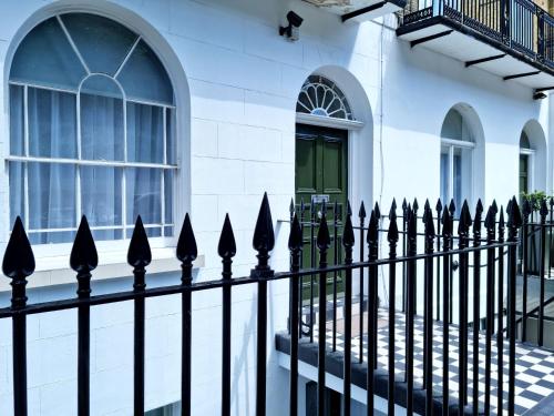 a black fence in front of a white building at 146 Studios in London