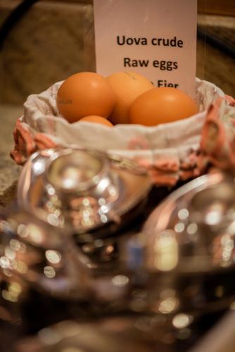 a bunch of eggs in bowls on a table at Hotel Cesa Tyrol in Canazei