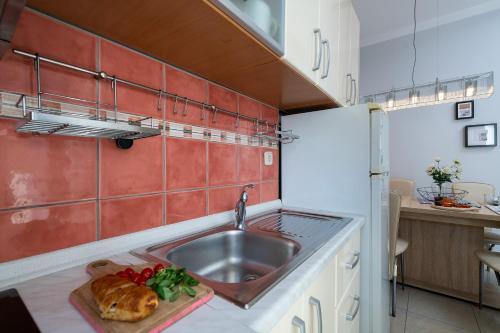 a kitchen with a sink and a counter top at Apartment Next To Amphitheatre in Pula