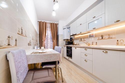 a white kitchen with a sink and a counter at URBAN LUXURY in Constanţa