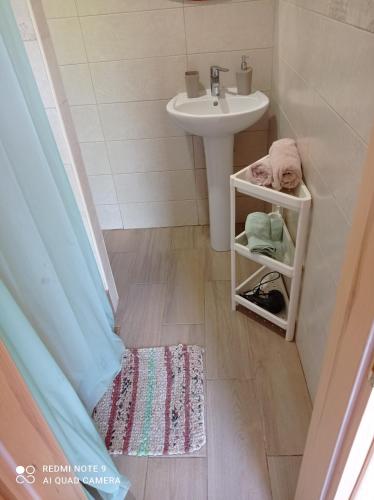 a small bathroom with a sink and a toilet and a sink at Inn Estio in Zatoka