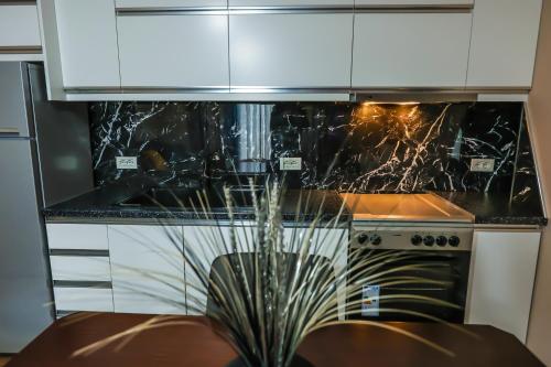a kitchen with a stove and a counter top at Edea's Apartment in Korçë