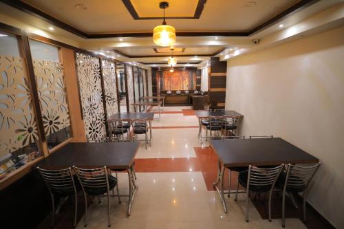a row of tables and chairs in a restaurant at Hotel Marygold in Agra