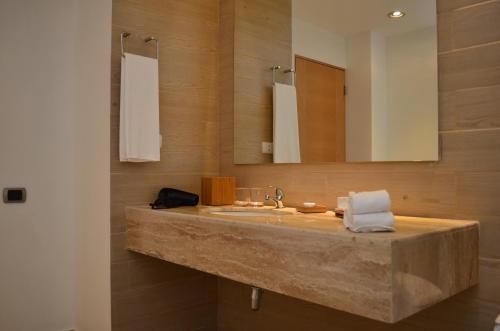 a bathroom with a sink and a mirror at Hotel Enjoy San Antonio in San Antonio