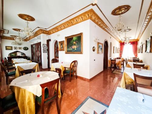 a restaurant with tables and chairs in a room at Euro Hotel Iglesias in Iglesias