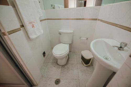 małą łazienkę z toaletą i umywalką w obiekcie Hostal Spring w mieście Huánuco