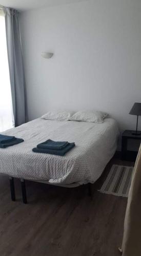 a bedroom with a bed with two towels on it at Hello Chloé in Vilamoura