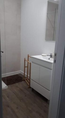 a white bathroom with a sink and a mirror at Hello Chloé in Vilamoura