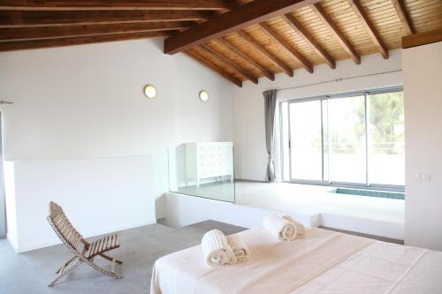 a bedroom with a bed and a large window at Villa Casa Rosa in Olhão