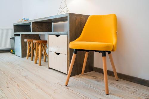 a yellow chair sitting in front of a desk at Montana 219 in Valea Drăganului
