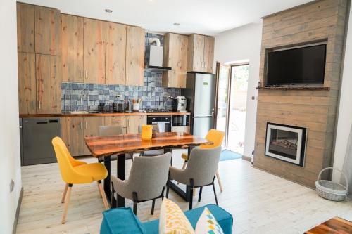 a kitchen with a wooden table and yellow chairs at Montana 219 in Valea Drăganului