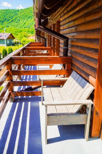 a wooden bench sitting on the side of a building at Montana 219 in Valea Drăganului