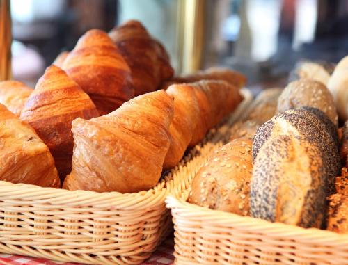 a bunch of different types of bread in baskets at Hotel Montana Zürich in Zürich