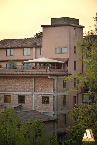an apartment building with a balcony on top of it at Hotel Athena in Siena
