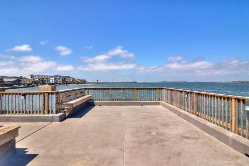 a boardwalk with benches and the ocean in the background at Channelview 206 in Port Aransas