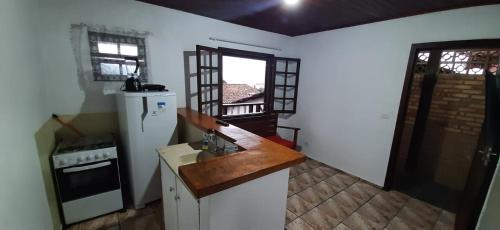 a kitchen with a sink and a counter top at chalé do Radiola in Ilhabela