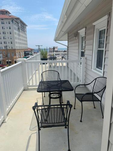 a patio with two chairs and a table on a balcony at Ocean Manor 1100 Inn in Ocean City