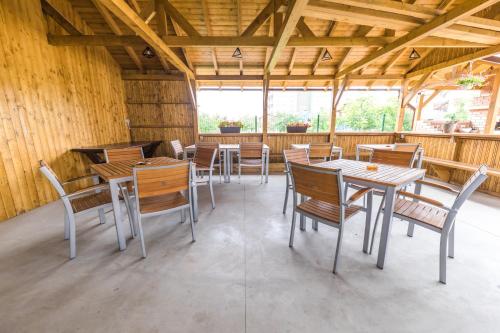 a dining room with tables and chairs in a building at Vila Coty in Mamaia Nord
