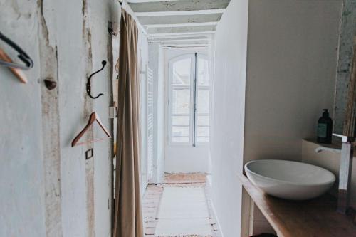 a bathroom with a white tub and a sink at Maison Séraphine - Guest house - Bed and Breakfast in Laon