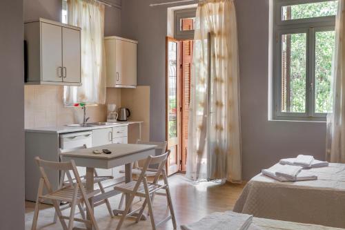 a kitchen with a table and chairs in a room at Narkissos 'SUPERB' in Chania Town