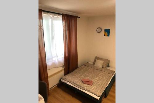 a small bedroom with a bed and a window at Quiet & Cozy Studio apartment on Baščaršija in Sarajevo