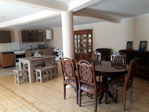 a dining room and kitchen with a table and chairs at Guesthouse Robi in Mestia