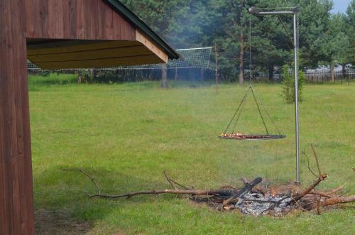 a swing over a fire in a field at Domki Pod Lasem in Macharce