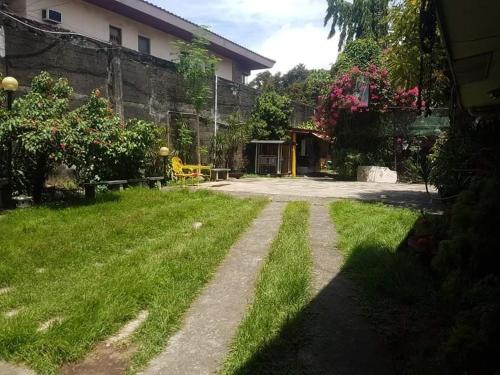 a yard with a dirt road in front of a house at The Terrace Room in Manila