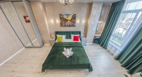 a hotel room with two beds and a chandelier at PEARL PREMIUM APARTMENTS 2 in Kyiv