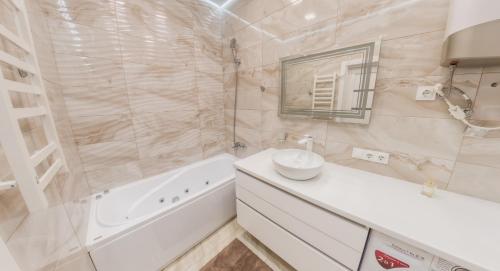 a white bathroom with a sink and a tub and a sink at PEARL PREMIUM APARTMENTS 2 in Kyiv
