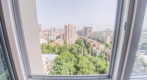a window with a view of a city at PEARL PREMIUM APARTMENTS 2 in Kyiv