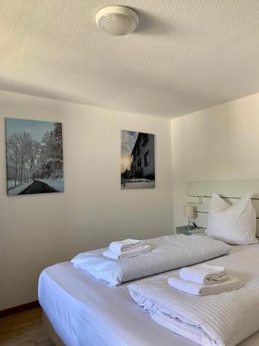 a bedroom with two beds with towels on them at Ferienwohnung Winterberg Lodge in Winterberg