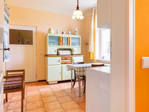 a kitchen with a table and a counter top at Authentic and cosy holidayhome with big beautifull garden in Altentreptow
