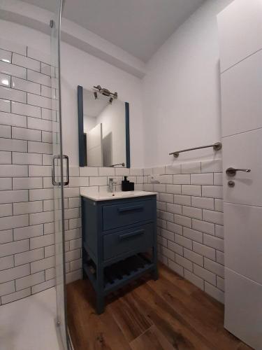 a bathroom with a sink and a mirror at Apartamentos El Muelle Comillas in Comillas