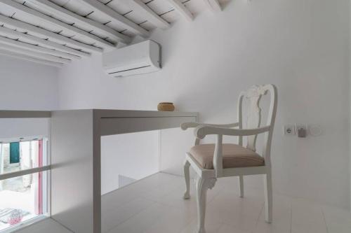 a chair sitting next to a desk in a room at Stella's House in Kimolos