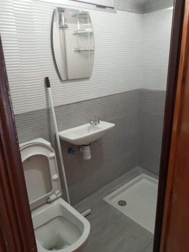 a small bathroom with a toilet and a sink at Almarsa4 in Al Hoceïma