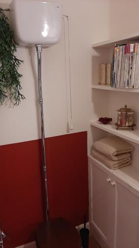 een lamp in een hoek van een kamer met een plank bij B&B del Giglio in Cefalù