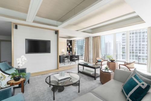 a living room with a couch and a tv at Shangri-La Singapore in Singapore