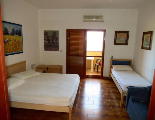 Postel nebo postele na pokoji v ubytování Residence Covo degli Dei