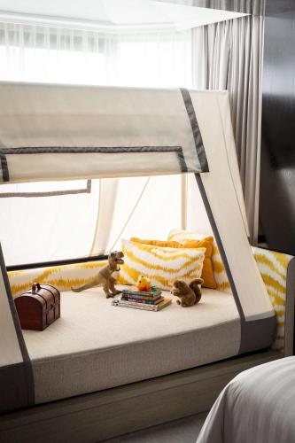 a bed in a bedroom with a bunk bed with toys at Shangri-La Singapore in Singapore