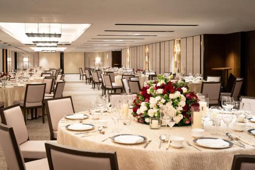 a banquet hall with tables and chairs and flowers at Shangri-La Singapore in Singapore