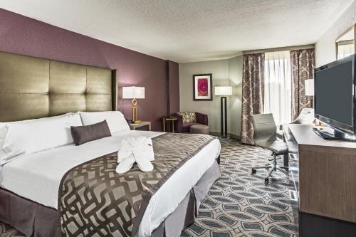 a hotel room with a large bed and a television at Crowne Plaza Saddle Brook, an IHG Hotel in Saddle Brook