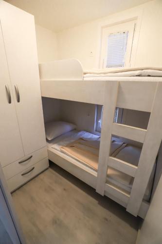 a small room with a bunk bed in it at Floating Sea House SONČEK in Portorož