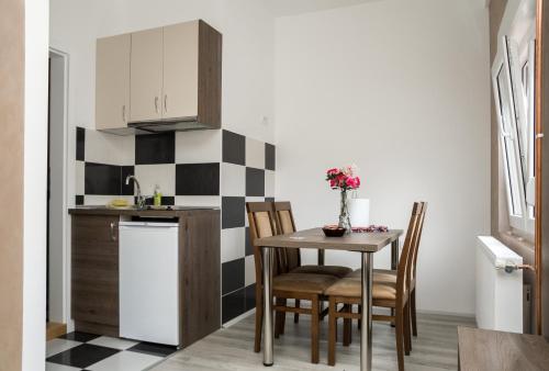 a kitchen with a table and chairs in a room at CITY APARTMENT BB in Bajina Bašta