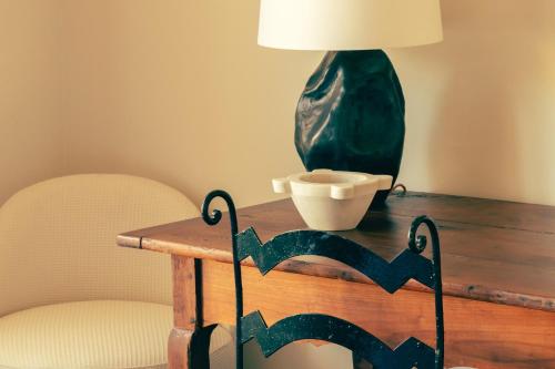 a table with a lamp and a bowl on it at Hotel la Ponche in Saint-Tropez