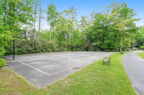 an empty basketball court in a park with a bench at Highland Haven in Newland
