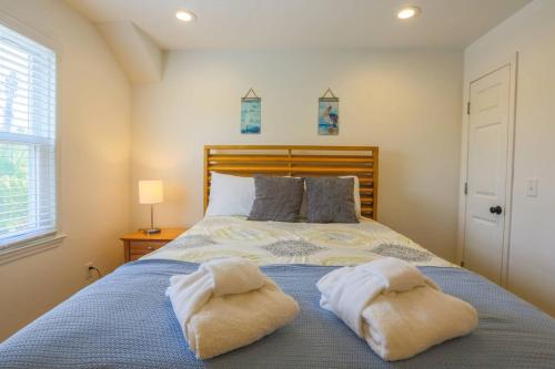 a bedroom with a bed with two towels on it at Carolina Breezes West in Isle of Palms