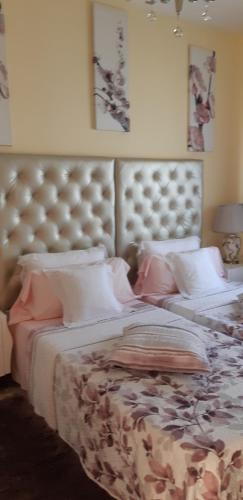a bedroom with a large bed with a large headboard at Exclusive Villa Romeo mit privaten Pool, mit herlichen Panoramameerblik auf den Atlant in Costa Calma