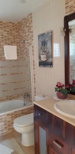 a bathroom with a toilet and a tub and a sink at Exclusive Villa Romeo mit privaten Pool, mit herlichen Panoramameerblik auf den Atlant in Costa Calma